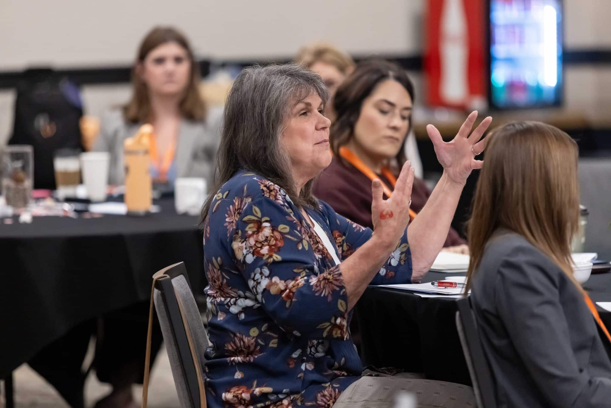 A woman smiling and engaged at the Women's Leadership Academy